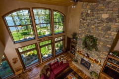 Kochmann Brothers Homes custom luxury lake home living room fireplace and windows to lake