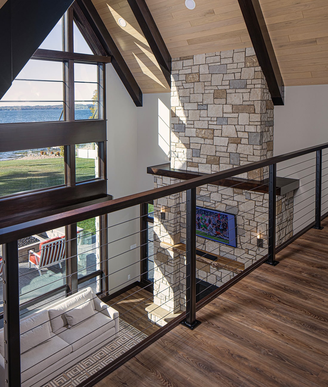 landing overlooking living room fireplace in lakehome cabin